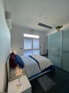 a bedroom with a bed and a table with a lamp at *Love'n fly apartament * Airport- Ducati in Bologna