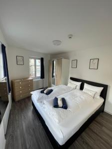 a bedroom with a large white bed with blue pillows at Haus zum Rütli in Chur