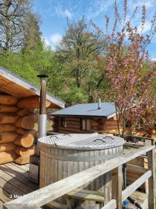 a log cabin with a hot tub on a deck at Mountain Edge Resort in Church Stretton
