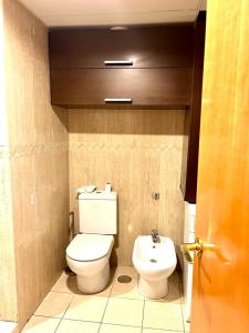 a bathroom with a toilet and a sink at LA TORRE I in Santa Cruz de Tenerife