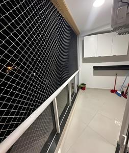 a hallway of a room with black and white tiles at aconchegante apt de 1 dormitorio in Rio de Janeiro