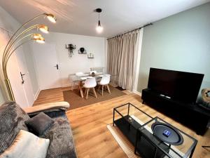 a living room with a couch and a table at Le P'tit Montreuillois - Appartement proche Paris in Montreuil