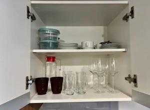 a cupboard with glasses and dishes on it with at Ap no Jaçatuba para locação in Santo André