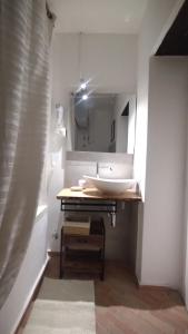 a white bathroom with a sink and a mirror at Plebiscito Suite Apartment in Naples
