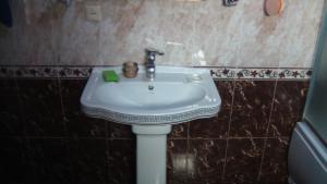 a bathroom with a white sink in a room at Mila Guest House in Mazeri