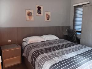 a bedroom with a bed and a nightstand next to it at Pengok Kidul 21 in Demangan
