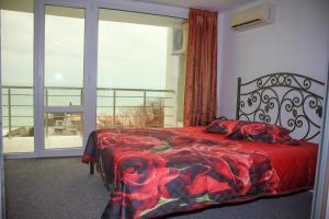 a bedroom with a bed and a large window at Апартаменти Дача in Varna City