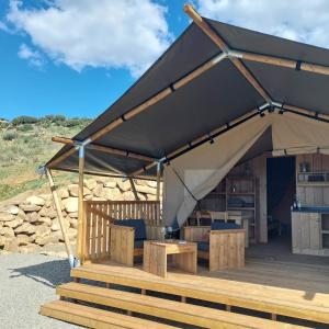 a canvas tent with a table and a desk at Glamping Vive Tus Suenos -Equilibrio- Caminito del Rey in Alora