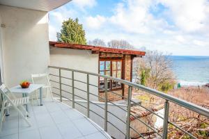 a balcony with a table and a view of the ocean at Апартаменти Дача in Varna City