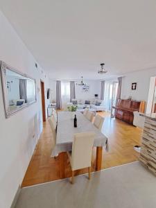 a dining room and living room with a table and chairs at Apartment Dijana in Dubrovnik