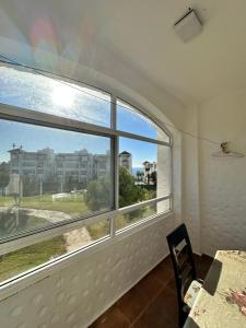 a room with a window with a view of a building at Appartement Asilah Marina Golf in Asilah