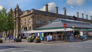 a large building with a market in front of it at Comfy House for Contractors, Families, Accrington in Accrington