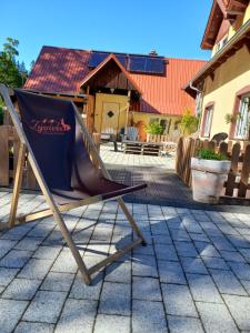 a deckchair sitting on a patio in front of a house at Zającówka - IDEALNA lokalizacja - leśna enklawa w centrum miasta! Sauna, masaże, zabiegi spa! in Szklarska Poręba