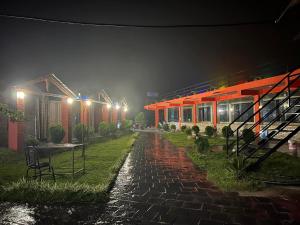 a rain soaked street at night with a train station at Sarangkot Toripani Homestay in Pokhara