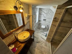 a bathroom with a sink and a shower at Rustic Caves Hotel in Göreme