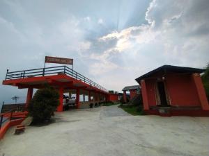 a red building with a sign on top of it at Sarangkot Toripani Homestay in Pokhara