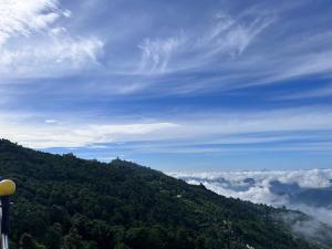 a view of a mountain with clouds in the sky at Sarangkot Toripani Homestay in Pokhara