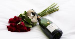 a bottle of wine next to a bouquet of roses at CUVEE J2 HOTEL OSAKA by Onko Chishin in Osaka