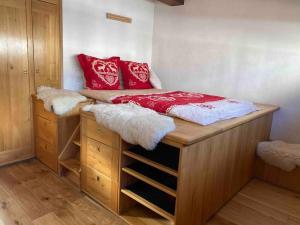 een bed met rode kussens erop in een slaapkamer bij 90m2 hypercentre, terrace, next to ski lift in Chamonix-Mont-Blanc