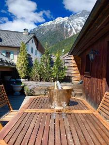 a wooden table on a patio with a mountain at 90m2 hypercentre, terrace, next to ski lift in Chamonix-Mont-Blanc