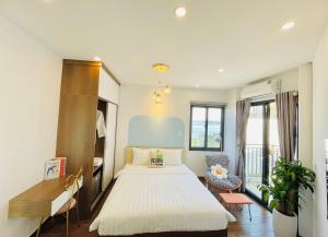 a hotel room with a bed and a desk at T98 Westlake Apartment in Hanoi