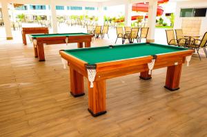 two pool tables in a room with chairs at LACQUA DiRoma 1 2 3 4 5 in Caldas Novas