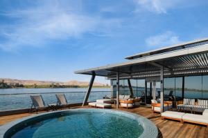 a swimming pool on the deck of a house on the water at AQUA THE DAHABEYA - Sundays from Luxor & Fridays from Aswan - Available for Private Bookings in Luxor