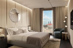 una camera con letto, specchio e sedia di Koenigshof, a Luxury Collection Hotel, Munich a Monaco