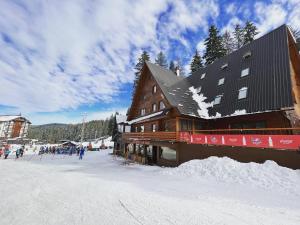a large building on a ski slope in the snow at Pansion A&M Vlašić in Vlasic