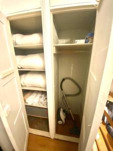 a room with a closet with a vacuum at Cozy nest in the heart of Helsinki in Helsinki