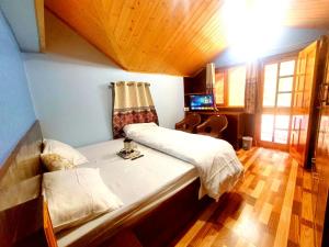 a bedroom with a large bed in a room at Pine Paradise Homestay in Shimla