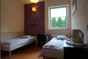 Postel nebo postele na pokoji v ubytování Hotelik Jankowski