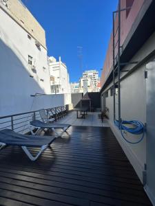 a balcony with chairs and tables on a ship at Thames Suite Plaza Italia in Buenos Aires