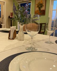 a table with two wine glasses and a plate on it at Cinque Terre Pousada & Bistrô in Rio de Janeiro