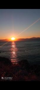 a sunset over a large body of water at Καραμπεικο in Piso Livadi