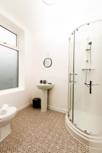 a bathroom with a shower and a toilet and a sink at Suite 5 - Stylist Spot in Oldham City Centre in Oldham