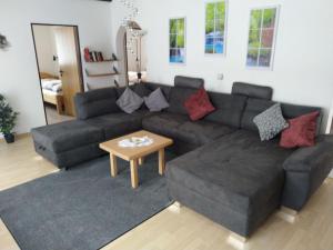 a living room with a couch and a table at Apartment Am Hohen Bogen-35 by Interhome in Arrach