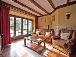 a living room with leather furniture and a coffee table at Holiday Home Oliveiras House - C in Sintra