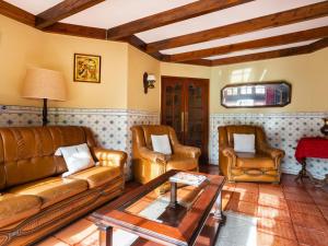 a living room with leather furniture and a table at Holiday Home Oliveiras House - C in Sintra