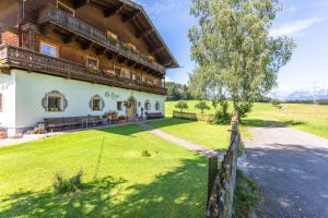 a house in the countryside with a fence at Stefflgut Appartements in Maishofen