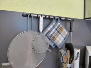 a table with a strainer and utensils in a kitchen at Apartment Apartment Enzian N-720 by Interhome in Beatenberg