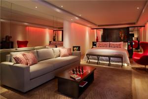 a living room with a couch and a bed at Double - Six, Luxury Hotel - Seminyak in Seminyak