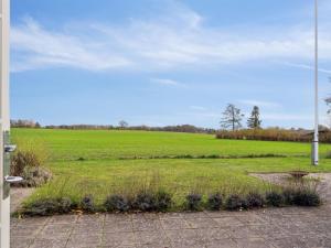 a view of a large field from a door at Holiday Home Mimi - all inclusive - 800m to the inlet by Interhome in Rørvig
