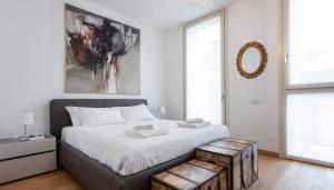a bedroom with a large bed and a mirror at Italianway - Albani 20 in Milan