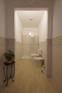 a bathroom with two toilets and a shower in it at Antica Dimora Siracusa in Arenella