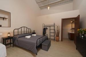 a bedroom with a bed and a bathroom at Antica Dimora Siracusa in Arenella
