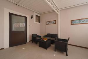 a waiting room with black chairs and a table at Antica Dimora Siracusa in Arenella