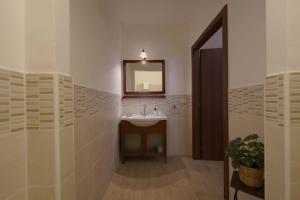 a bathroom with a sink and a mirror at Antica Dimora Siracusa in Arenella +26 photos