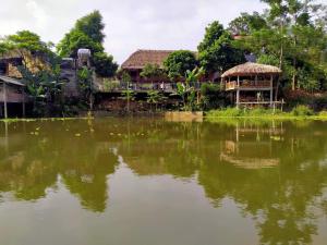 a reflection of a train in a body of water at Dao homestay Vũ Linh in Yên Bình