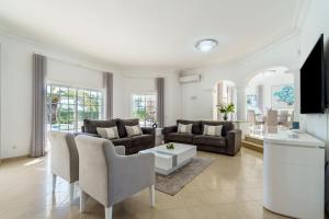 a living room with a couch and a table at Alcore Luxury Golf Villa at Alto Golf Alvor in Alvor